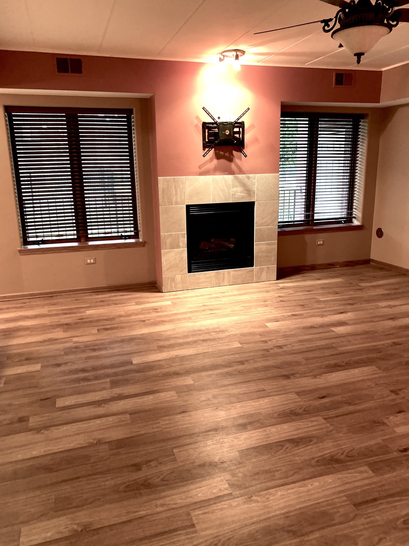 2321 183rd Street, Unit 101 Homewood, IL 60430 - Photo 3 of 27 a view of empty room with wooden floor and fireplace