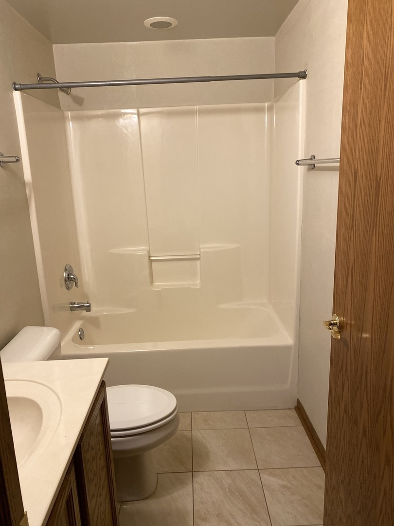 2321 183rd Street, Unit 101 Homewood, IL 60430 - Photo 24 of 27 a bathroom with a sink toilet and shower