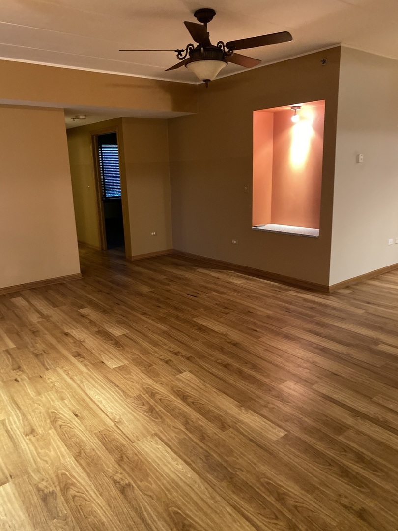 2321 183rd Street, Unit 101 Homewood, IL 60430 - Photo 8 of 27 a view of an empty room with wooden floor and a window