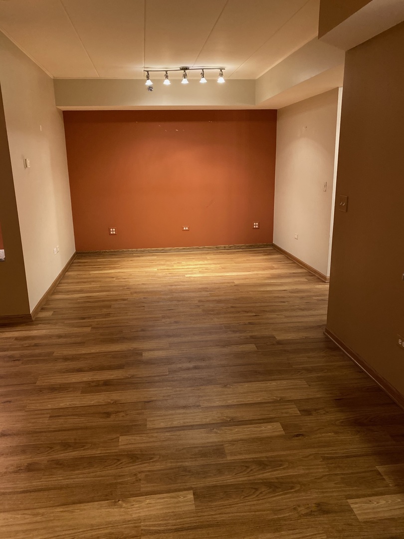 2321 183rd Street, Unit 101 Homewood, IL 60430 - Photo 9 of 27 a view of an empty room with wooden floor