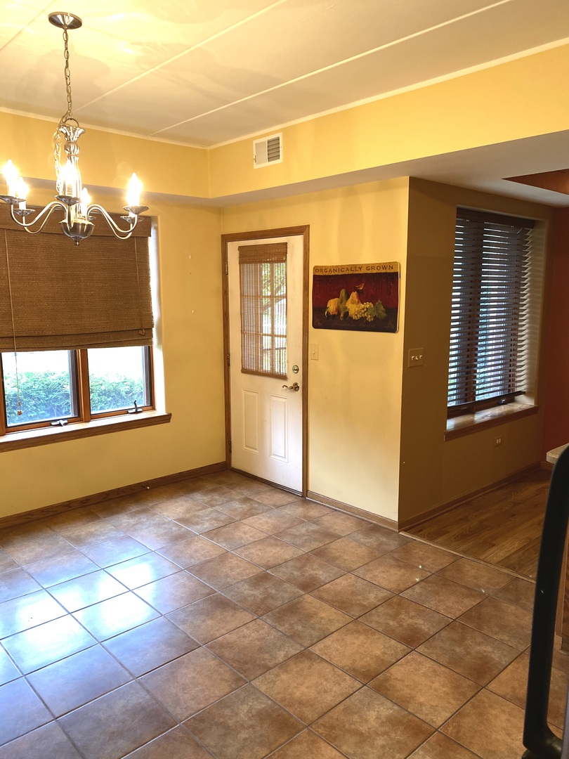 2321 183rd Street, Unit 101 Homewood, IL 60430 - Photo 10 of 27 a view of a room with a chandeliers