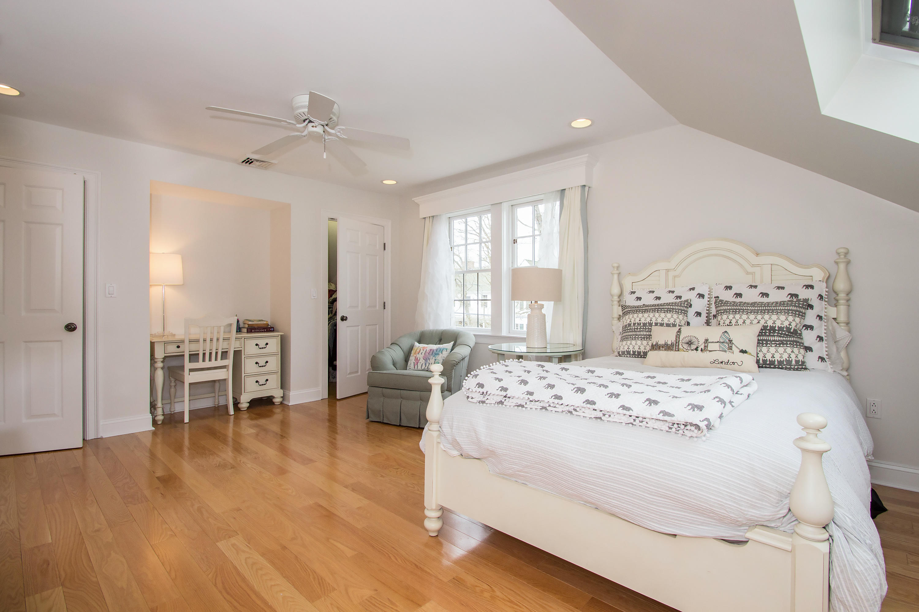 7 Ensign Road Norwalk, CT 06853 - Photo 19 of 25 a bedroom with a large bed and a chandelier