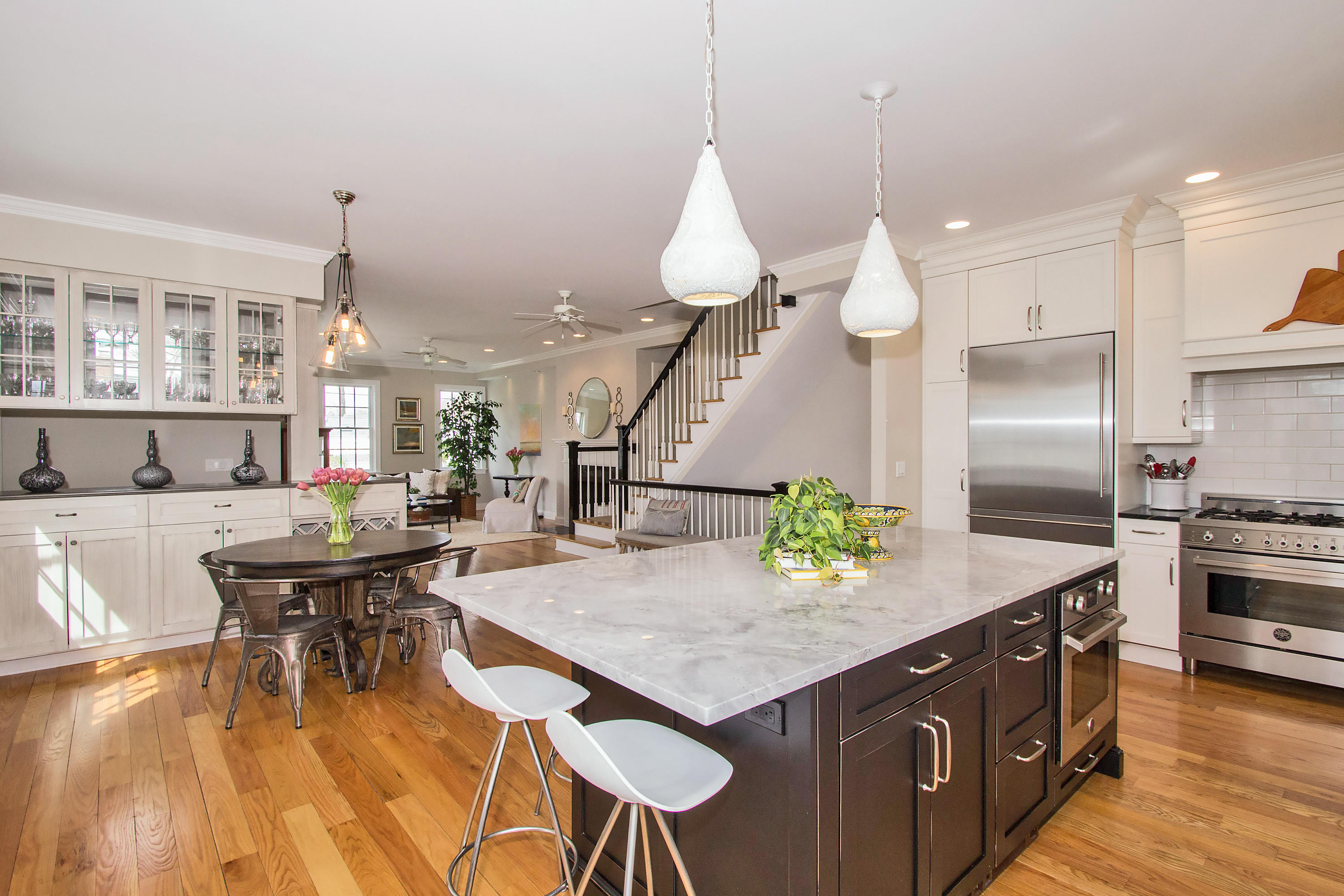 7 Ensign Road Norwalk, CT 06853 - Photo 4 of 25 a kitchen with a table chairs appliances and wooden floor