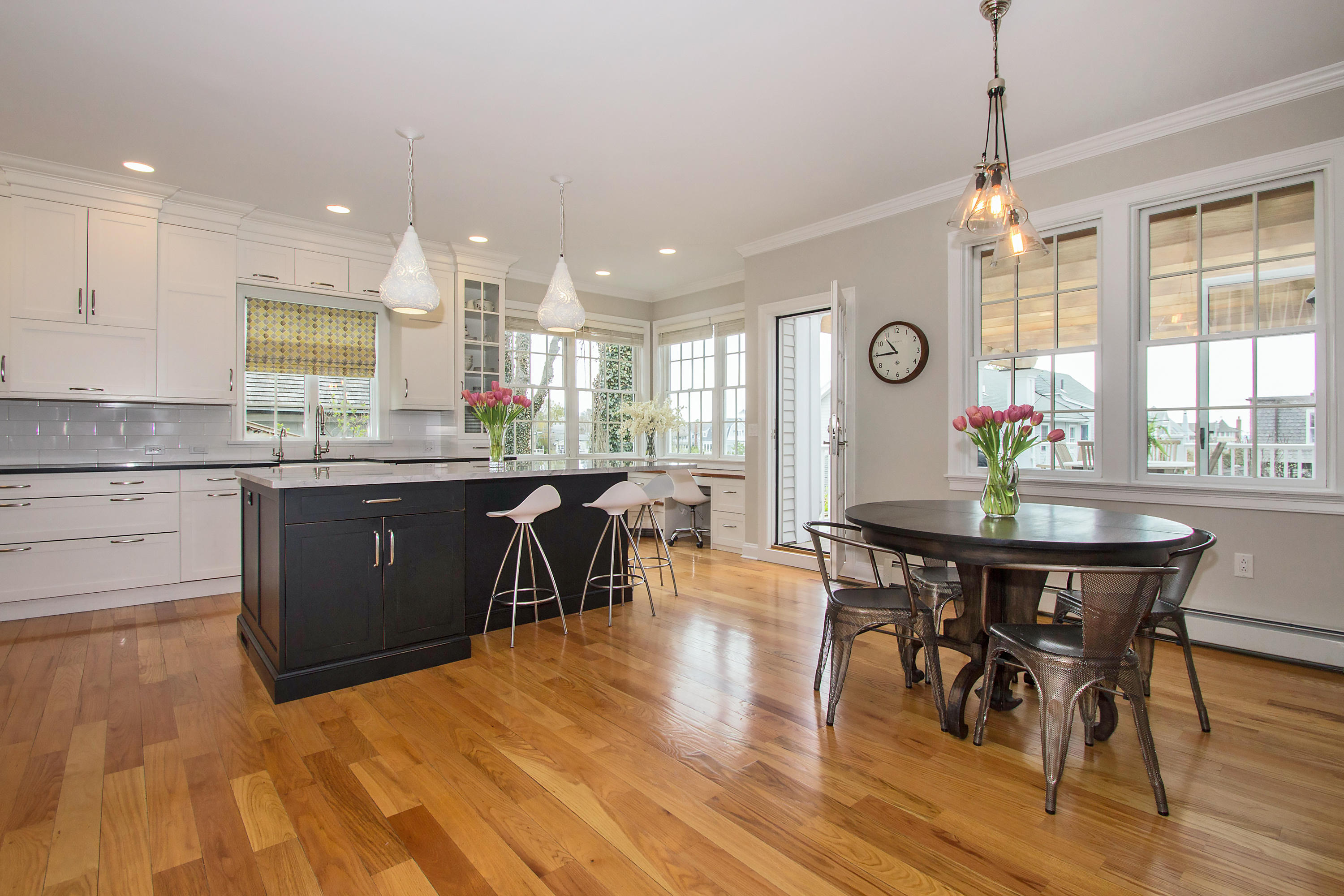 7 Ensign Road Norwalk, CT 06853 - Photo 6 of 25 a kitchen with stainless steel appliances granite countertop a dining table chairs stove a refrigerator and a window with wooden floors