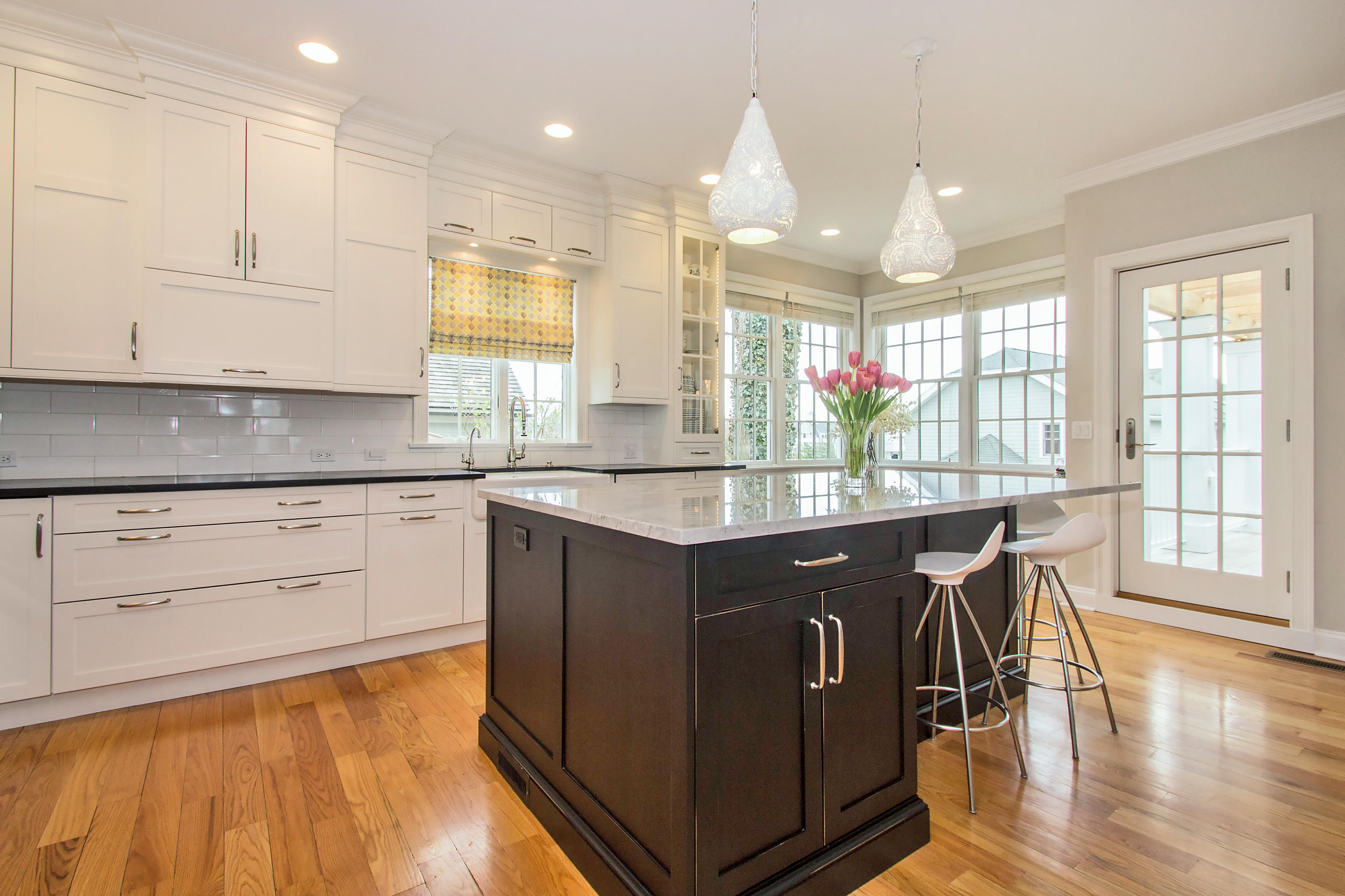 7 Ensign Road Norwalk, CT 06853 - Photo 7 of 25 a kitchen with stainless steel appliances granite countertop a sink a stove a dining table and chairs