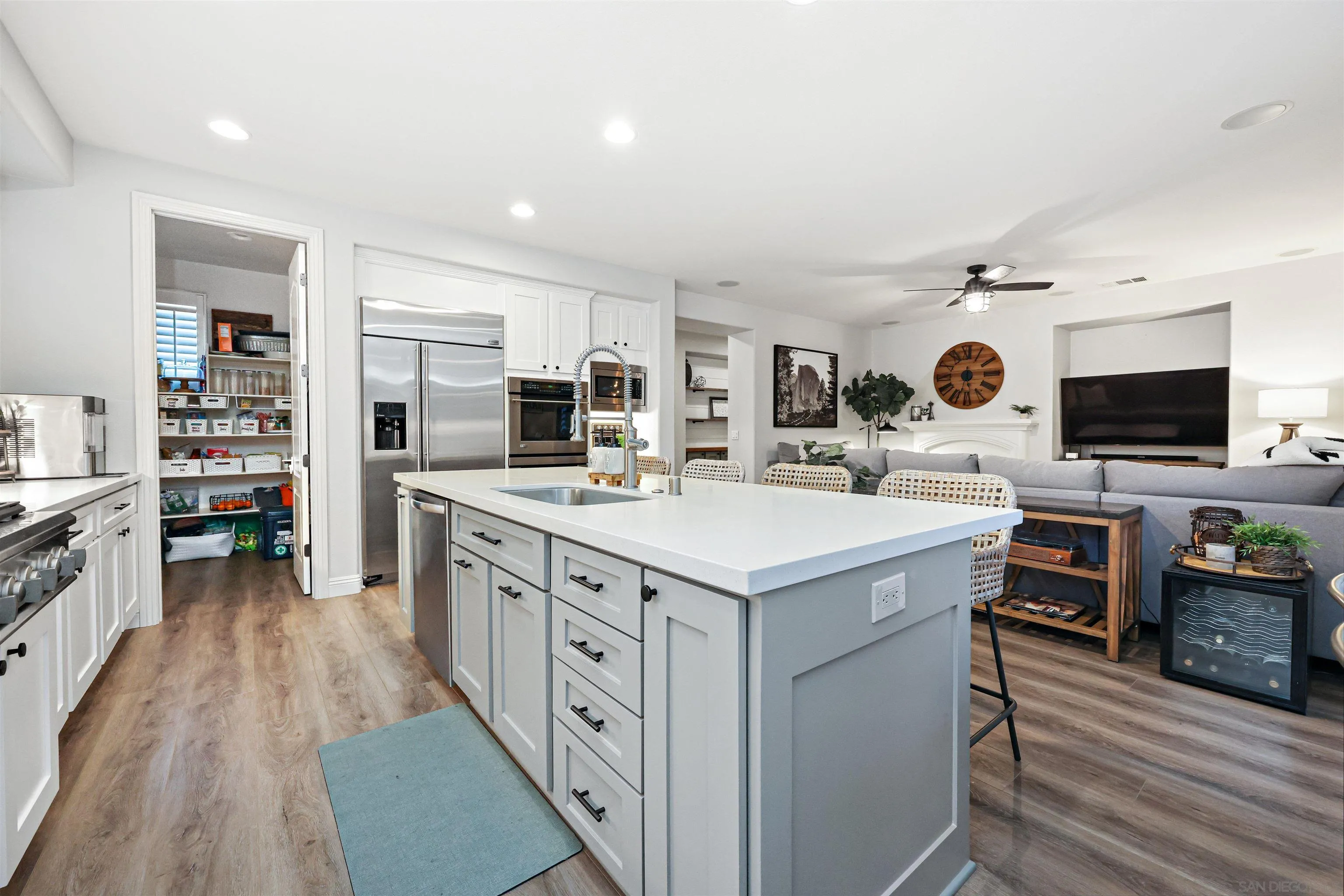 1431 Eclipse Drive San Marcos, CA 92078 - Photo 11 of 39 a kitchen with stainless steel appliances a sink a stove top oven a counter space and cabinets