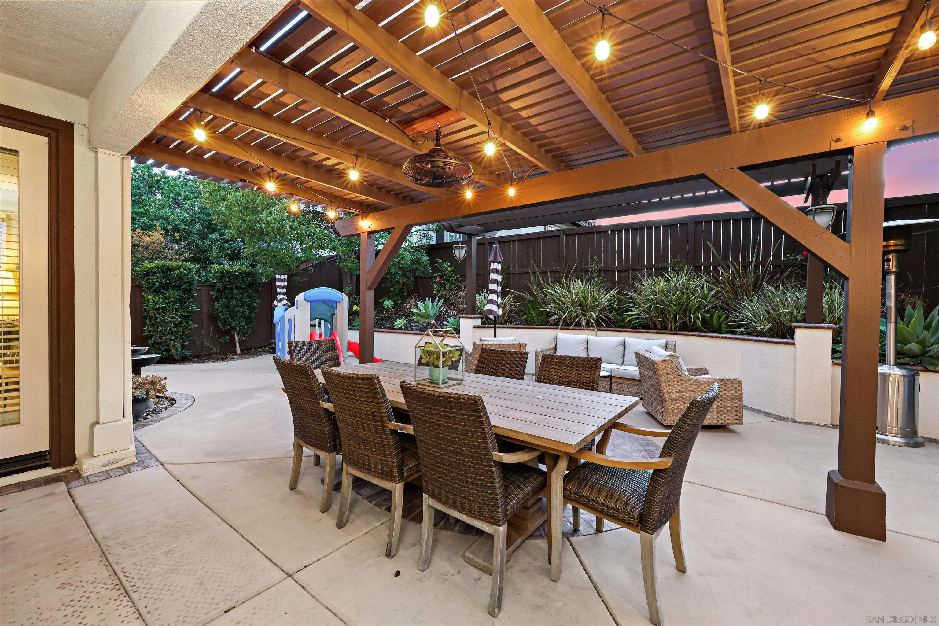 1431 Eclipse Drive San Marcos, CA 92078 - Photo 14 of 39 a view of a patio with a table and chairs under a roof