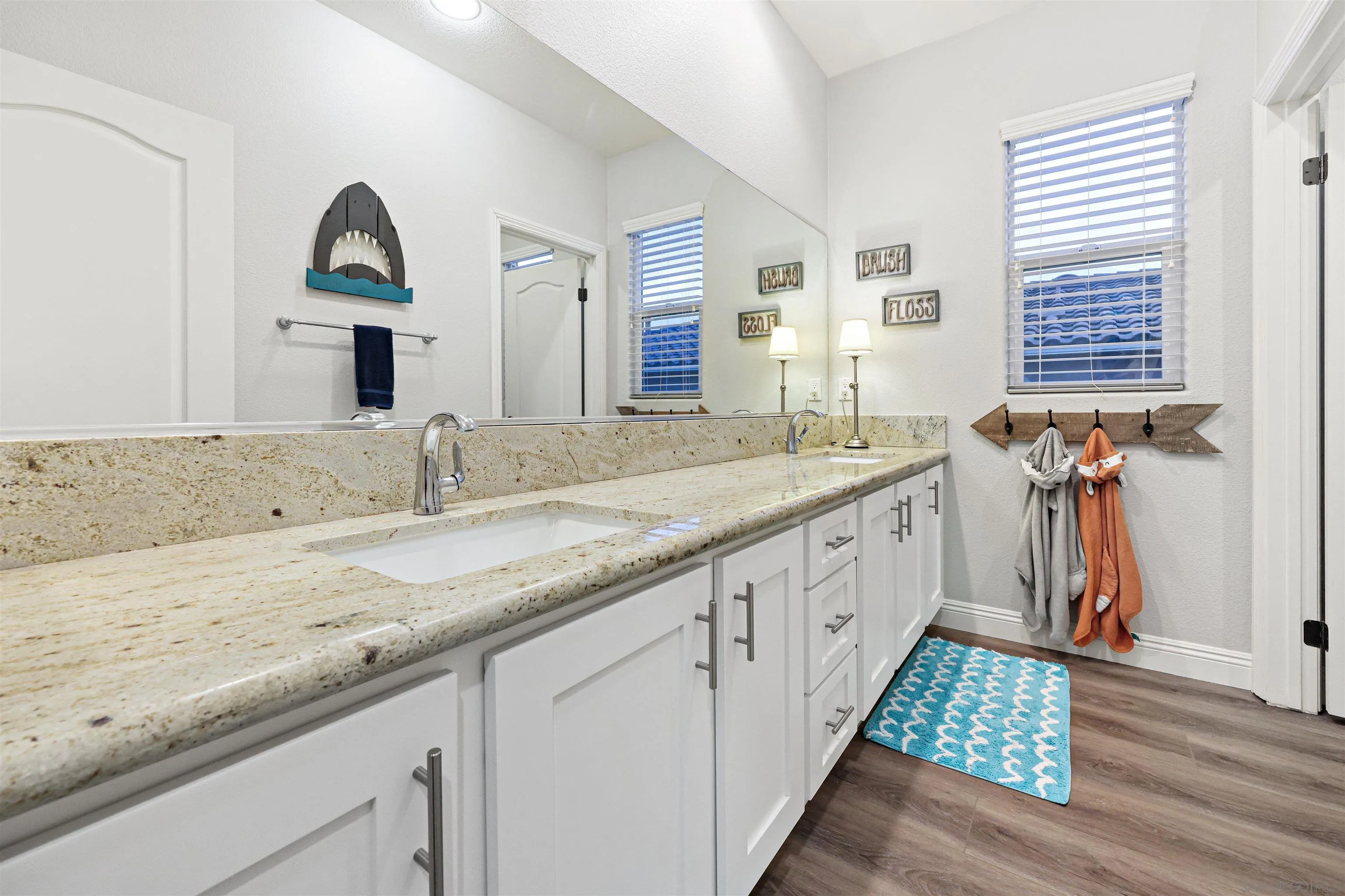 1431 Eclipse Drive San Marcos, CA 92078 - Photo 35 of 39 a bathroom with a double vanity sink and a window