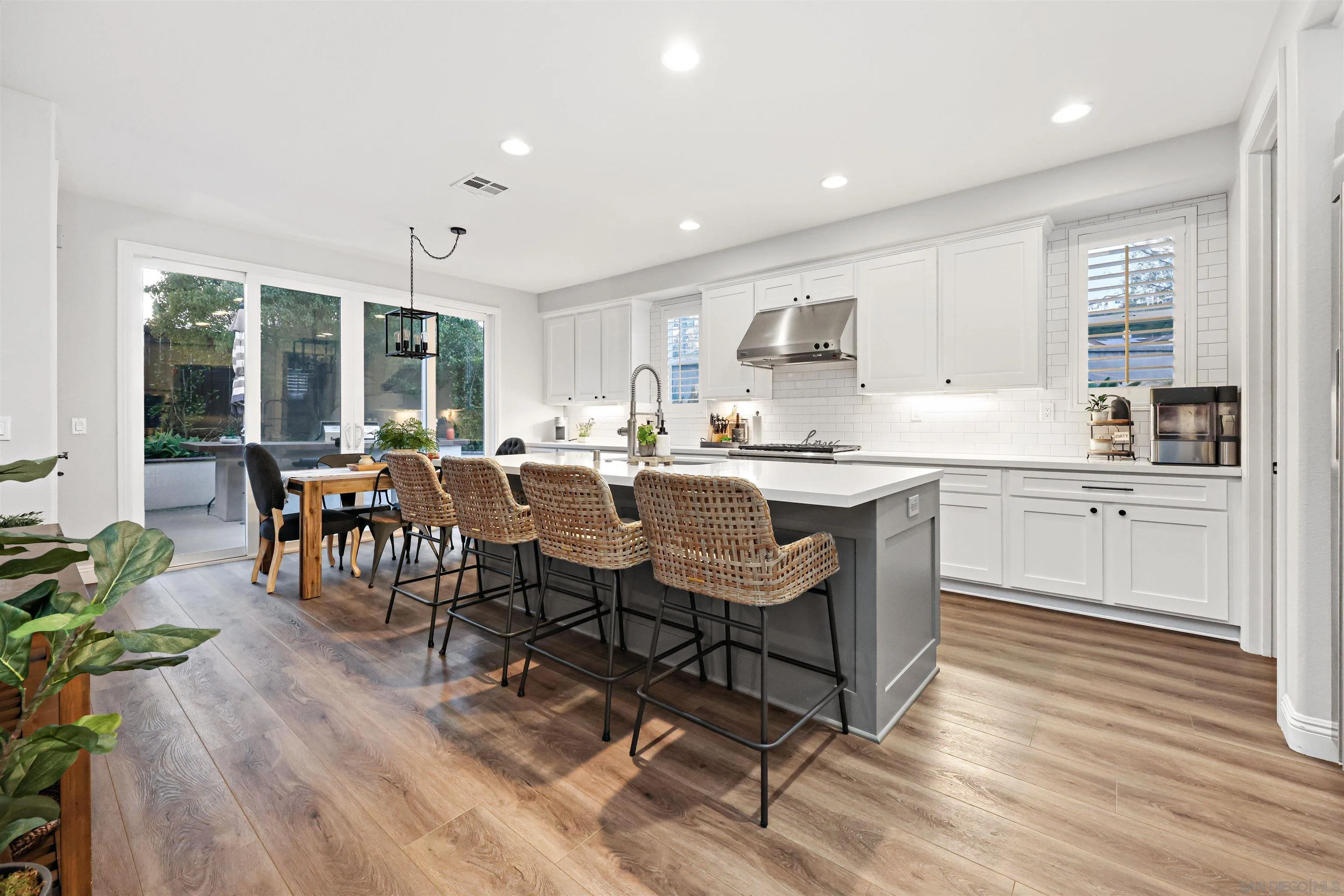 1431 Eclipse Drive San Marcos, CA 92078 - Photo 10 of 39 a kitchen with a dining table chairs and white appliances