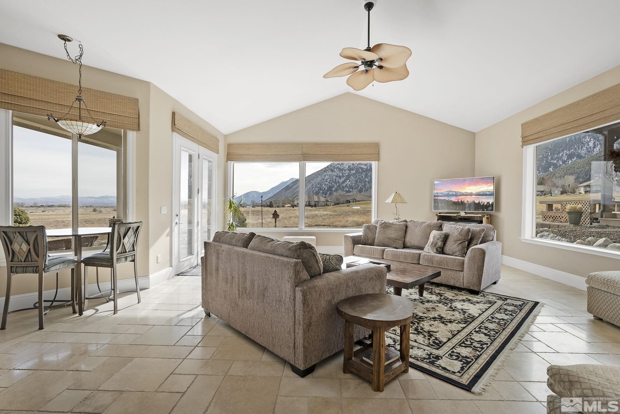2425 Genoa Meadows Circle Genoa, NV 89411 - Photo 11 of 40 a living room with furniture a large window and a table