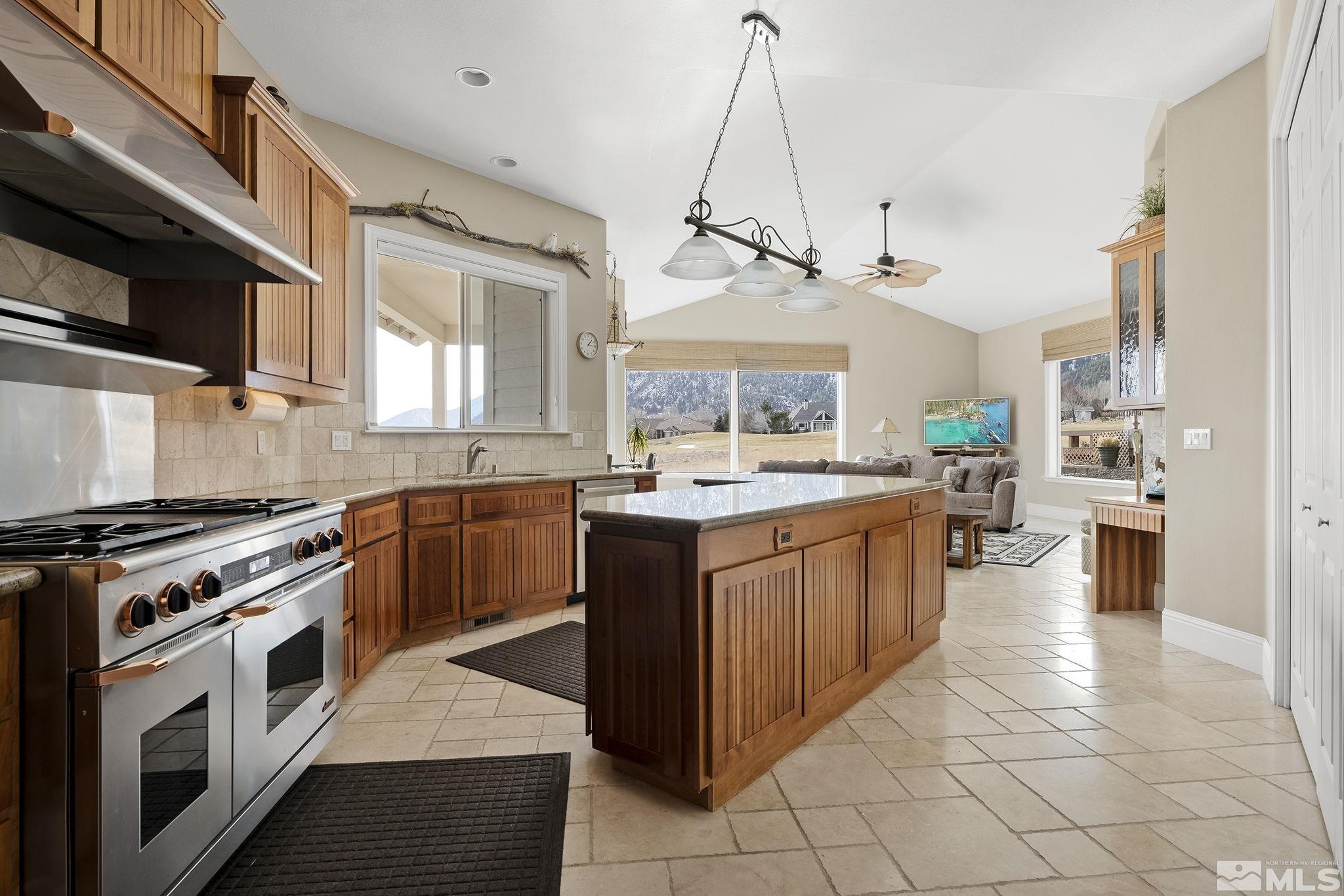 2425 Genoa Meadows Circle Genoa, NV 89411 - Photo 16 of 40 a kitchen with stainless steel appliances granite countertop a stove top oven a sink a counter top space and cabinets