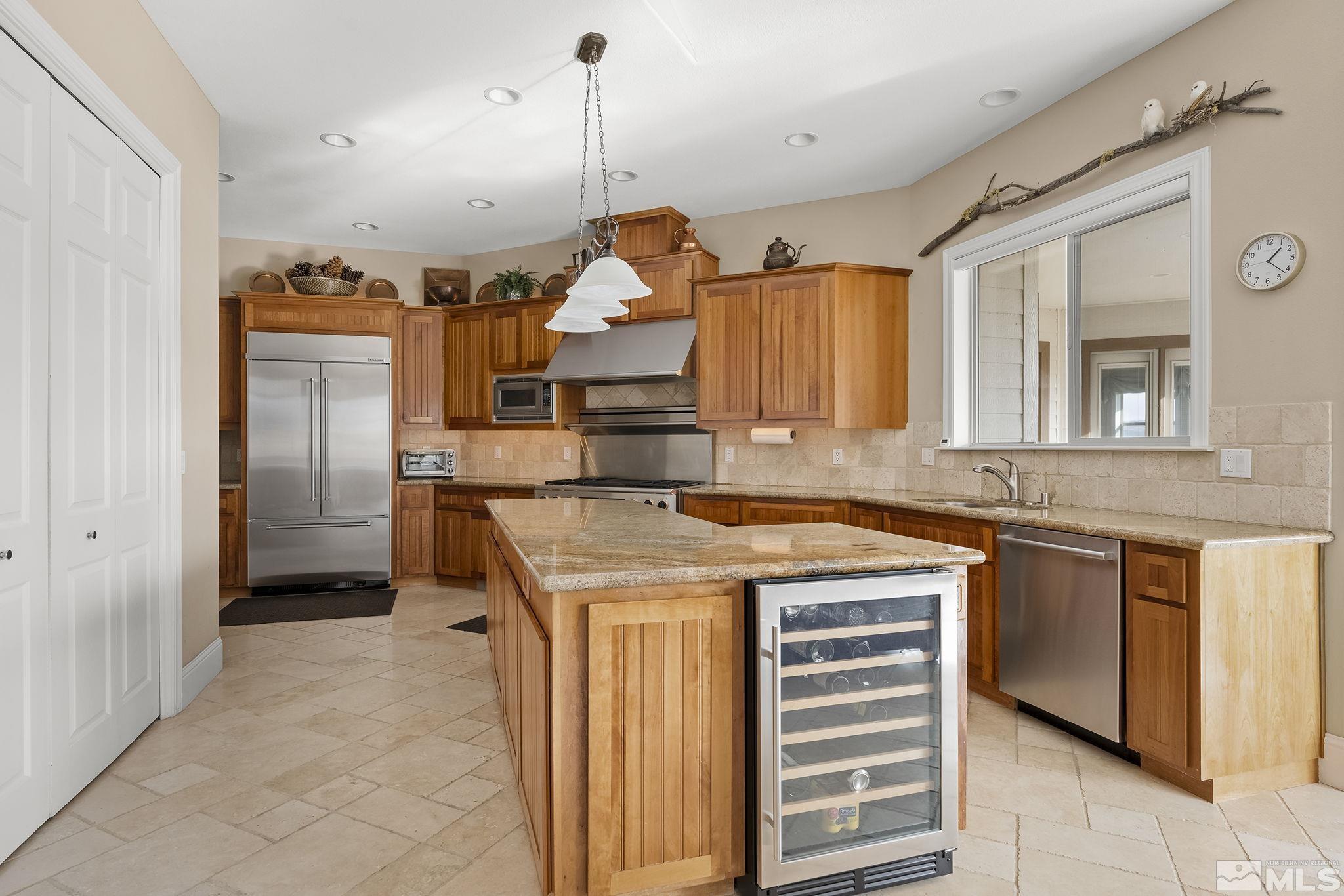 2425 Genoa Meadows Circle Genoa, NV 89411 - Photo 18 of 40 a kitchen that has a lot of cabinets in it