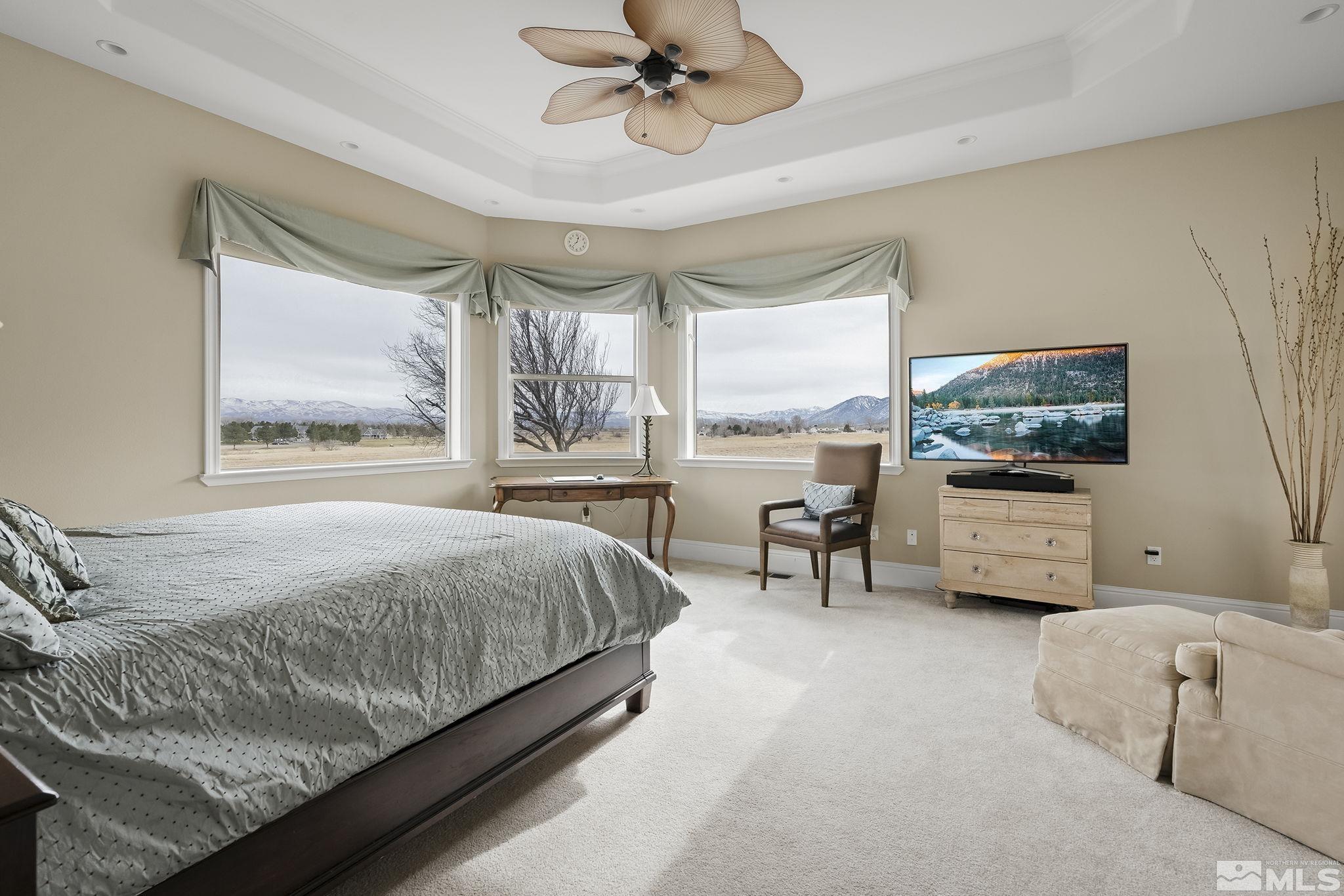 2425 Genoa Meadows Circle Genoa, NV 89411 - Photo 19 of 40 a bedroom with a bed and a flat screen tv
