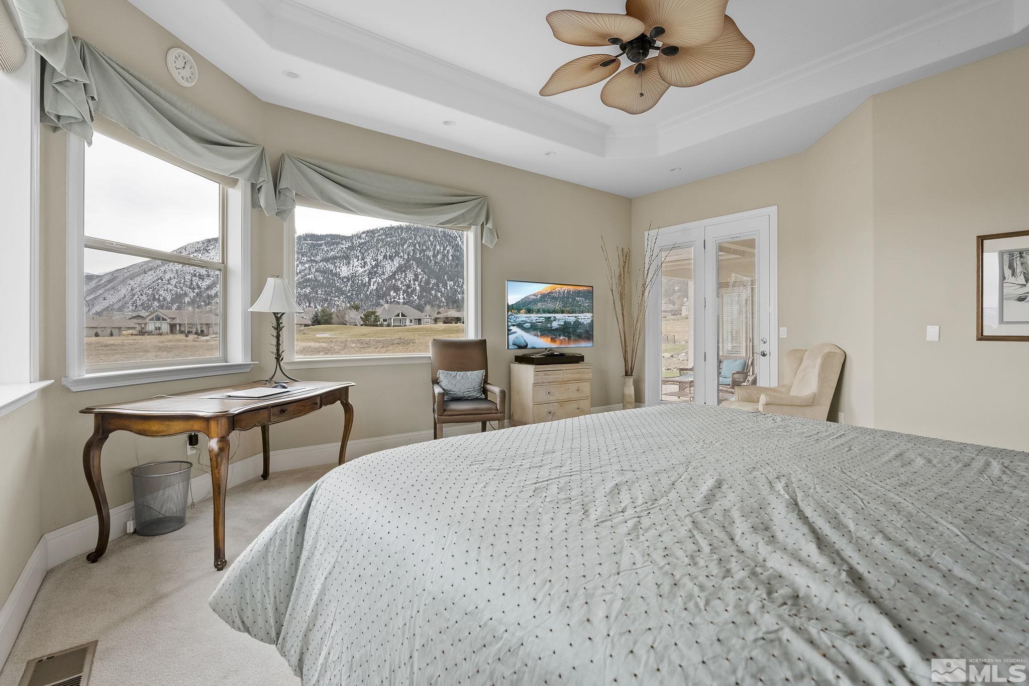 2425 Genoa Meadows Circle Genoa, NV 89411 - Photo 20 of 40 a bedroom with a bed and a chandelier