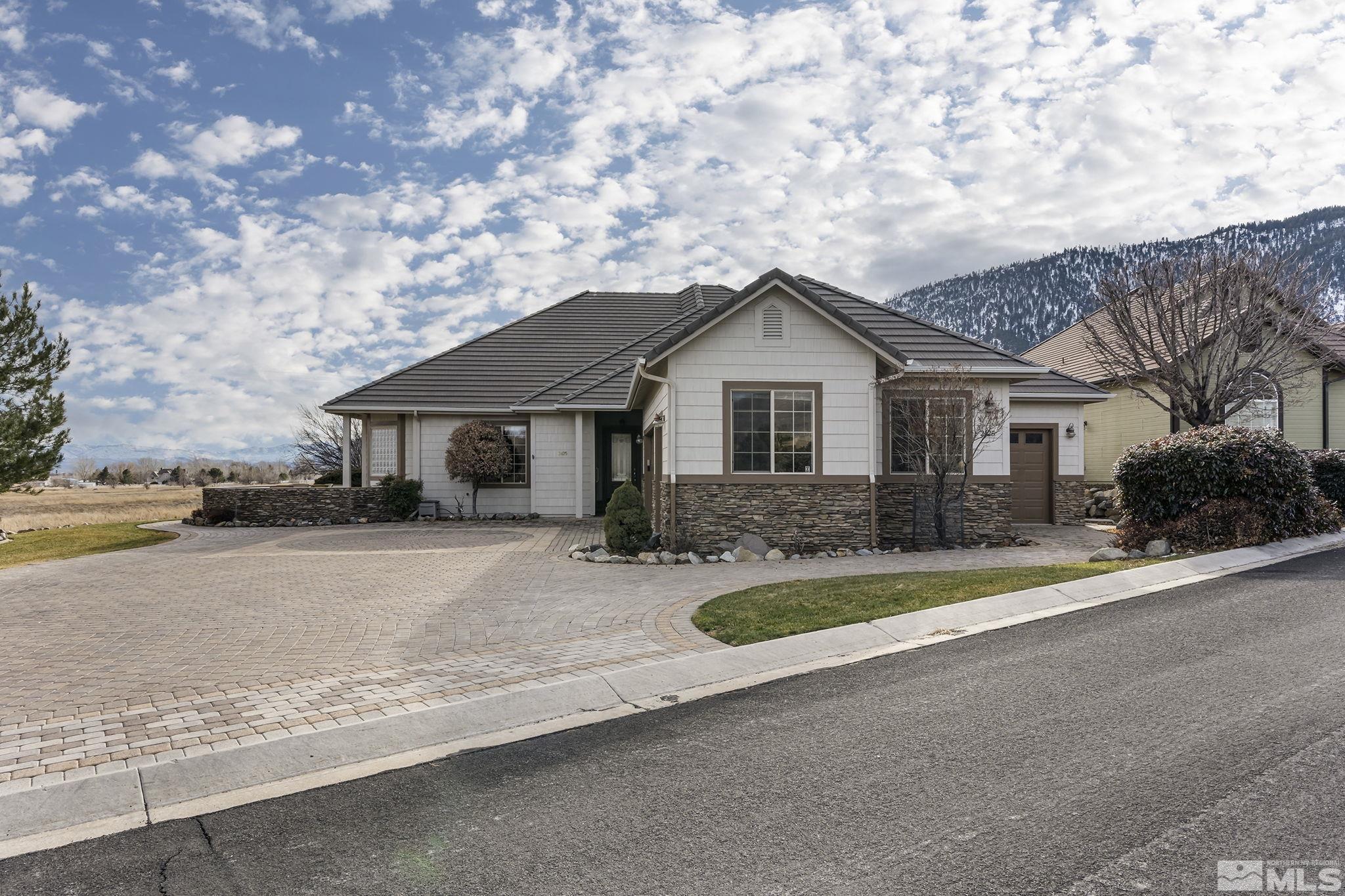 2425 Genoa Meadows Circle Genoa, NV 89411 - Photo 2 of 40 a front view of a house with yard patio and garage