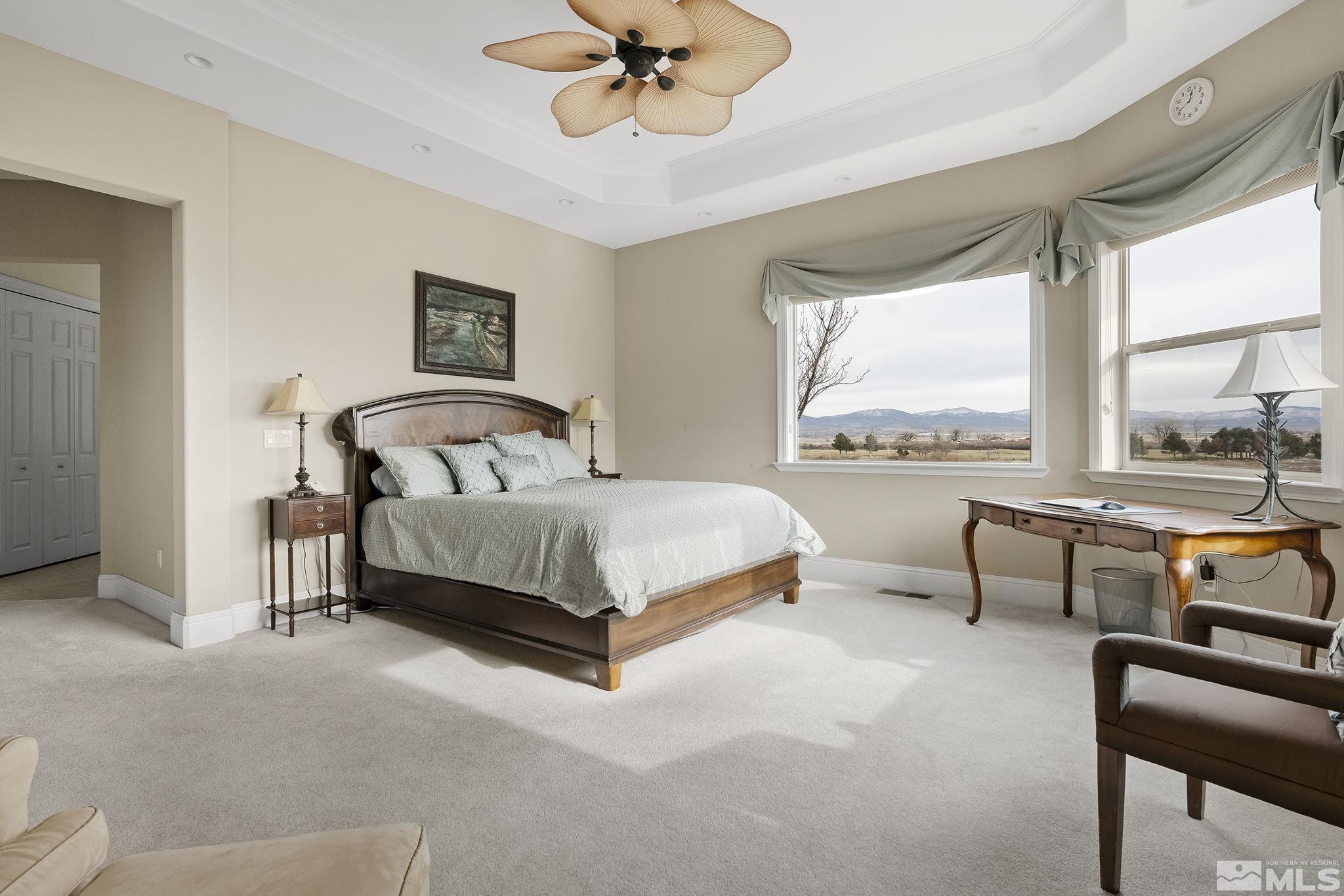 2425 Genoa Meadows Circle Genoa, NV 89411 - Photo 21 of 40 a bedroom with a bed and a chandelier