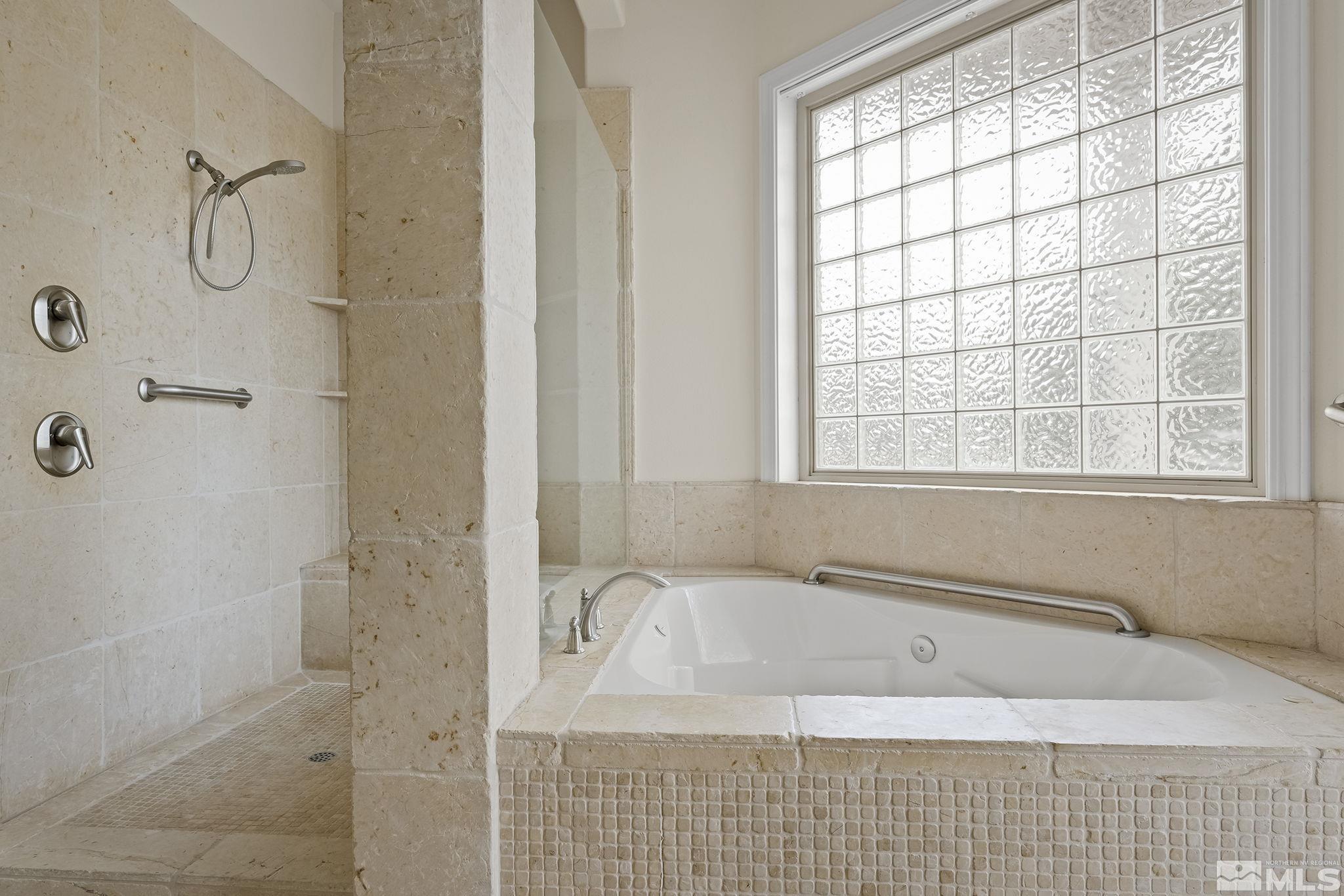 2425 Genoa Meadows Circle Genoa, NV 89411 - Photo 23 of 40 a bathroom with a bathtub and shower