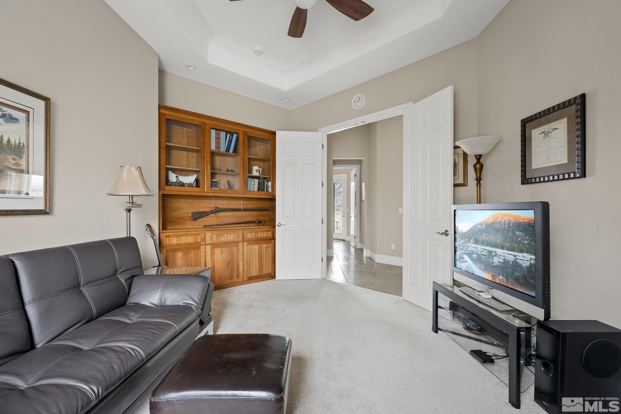 2425 Genoa Meadows Circle Genoa, NV 89411 - Photo 25 of 40 a living room with furniture and a flat screen tv