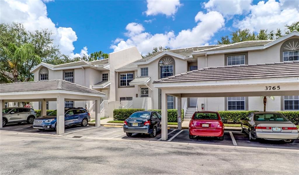 a view of a cars park in front of a building