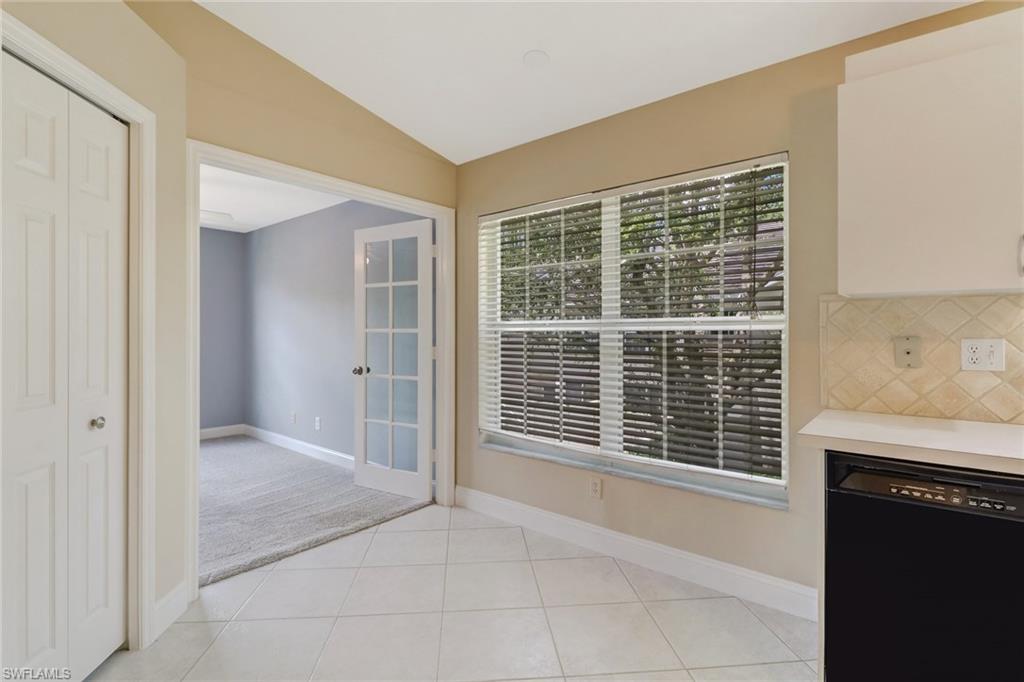 3765 Fieldstone Boulevard, Unit 1304 Naples, FL 34109 - Photo 13 of 33 a view of an empty room with a fireplace