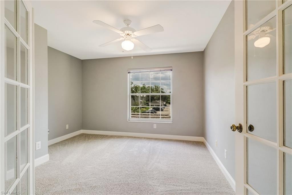 3765 Fieldstone Boulevard, Unit 1304 Naples, FL 34109 - Photo 15 of 33 a view of an empty room with a window