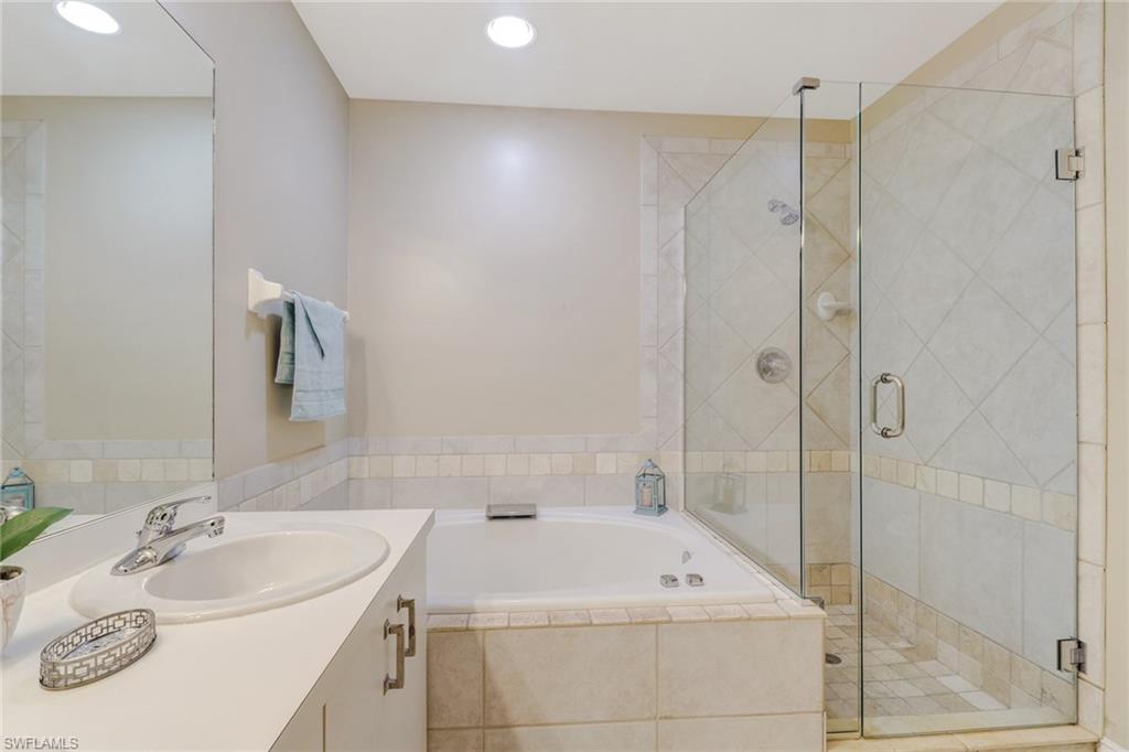 3765 Fieldstone Boulevard, Unit 1304 Naples, FL 34109 - Photo 20 of 33 a bathroom with a sink and a mirror