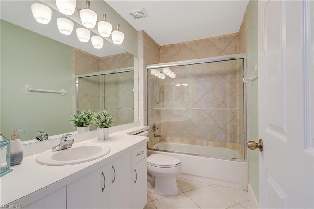 3765 Fieldstone Boulevard, Unit 1304 Naples, FL 34109 - Photo 24 of 33 a bathroom with a sink toilet tub and shower