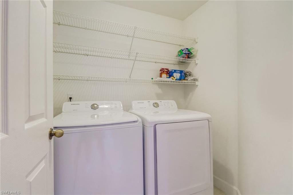 3765 Fieldstone Boulevard, Unit 1304 Naples, FL 34109 - Photo 25 of 33 a utility room with dryer and washer