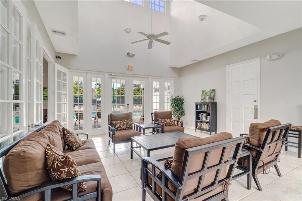 3765 Fieldstone Boulevard, Unit 1304 Naples, FL 34109 - Photo 32 of 33 a living room with furniture and a large window