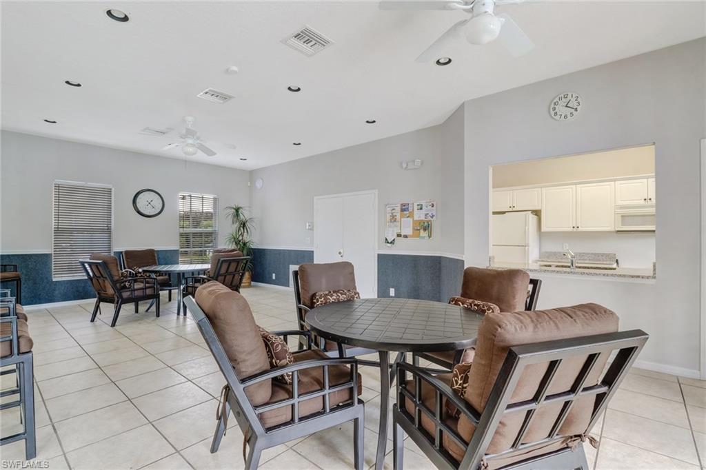 3765 Fieldstone Boulevard, Unit 1304 Naples, FL 34109 - Photo 33 of 33 a view of a dining room with furniture and wooden floor