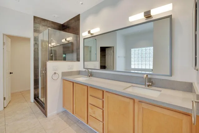 a bathroom with a double vanity sink and mirror