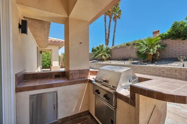 a view of a kitchen with a sink and potted plant