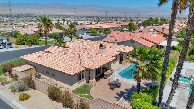 an aerial view of a house with garden space and street view