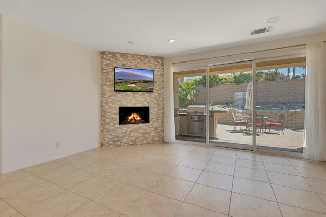 a view of an empty room with a fireplace