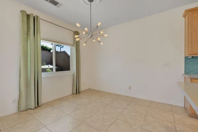wooden floor in an empty room and a kitchen