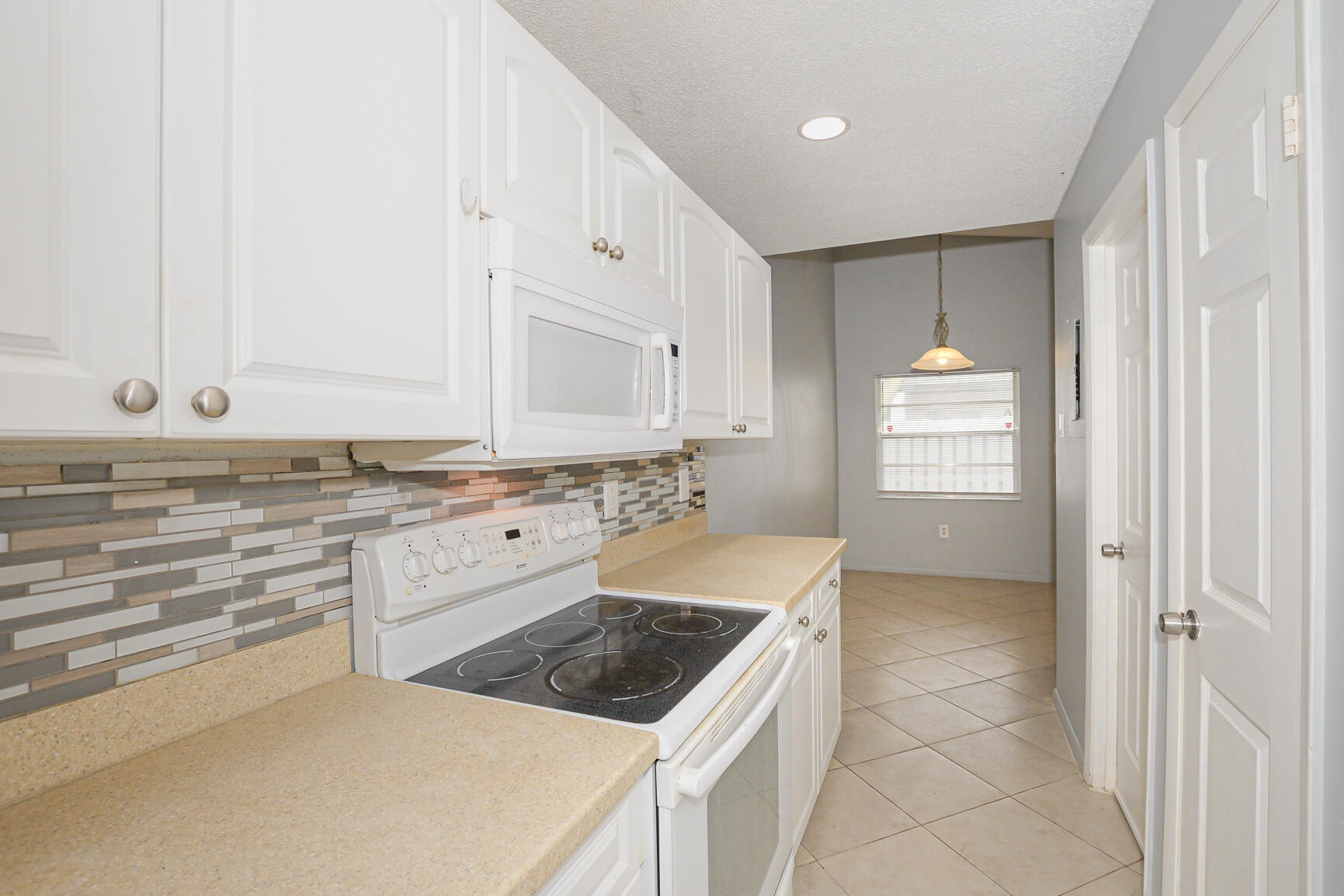 2007 Oleander Boulevard, Unit B Fort Pierce, FL 34950 - Photo 13 of 21 a kitchen with granite countertop white cabinets and white appliances