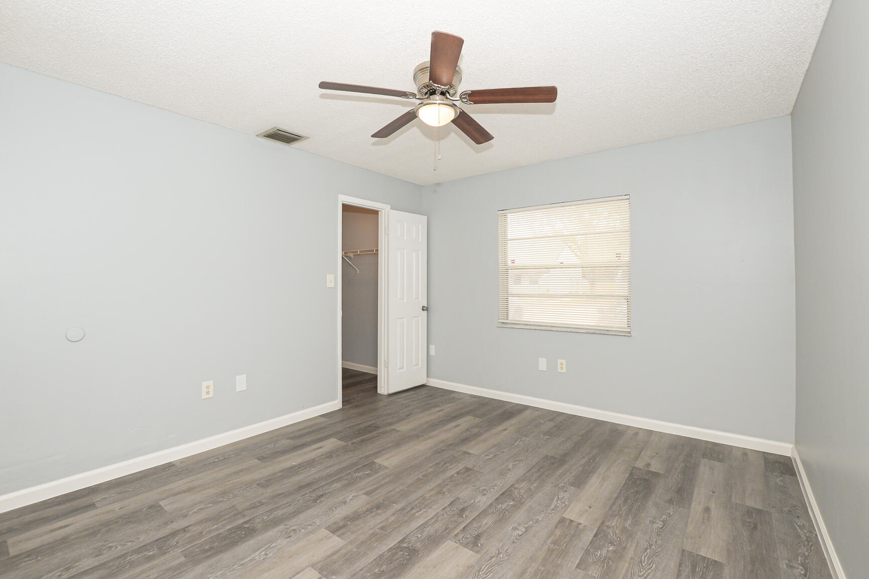 2007 Oleander Boulevard, Unit B Fort Pierce, FL 34950 - Photo 15 of 21 a view of an empty room with wooden floor and a window