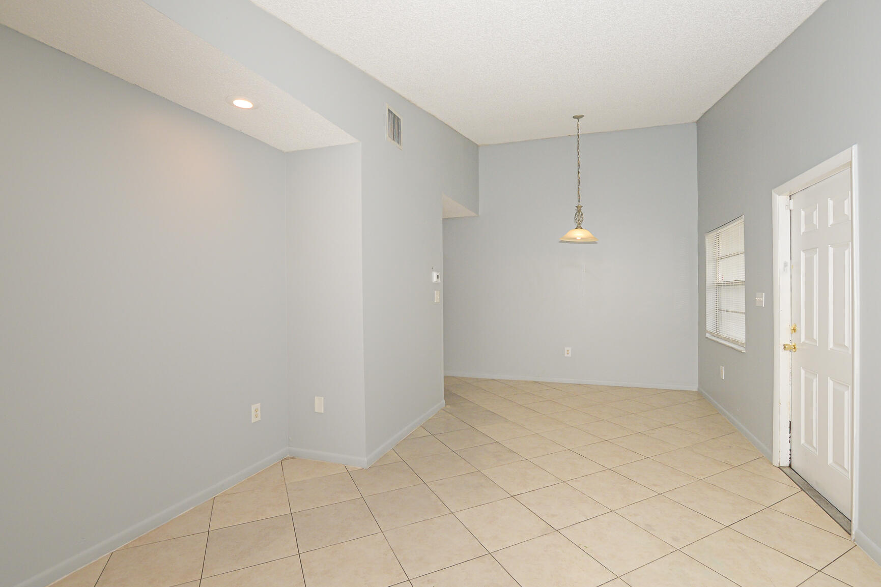 2007 Oleander Boulevard, Unit B Fort Pierce, FL 34950 - Photo 6 of 21 wooden floor in an empty room with a window