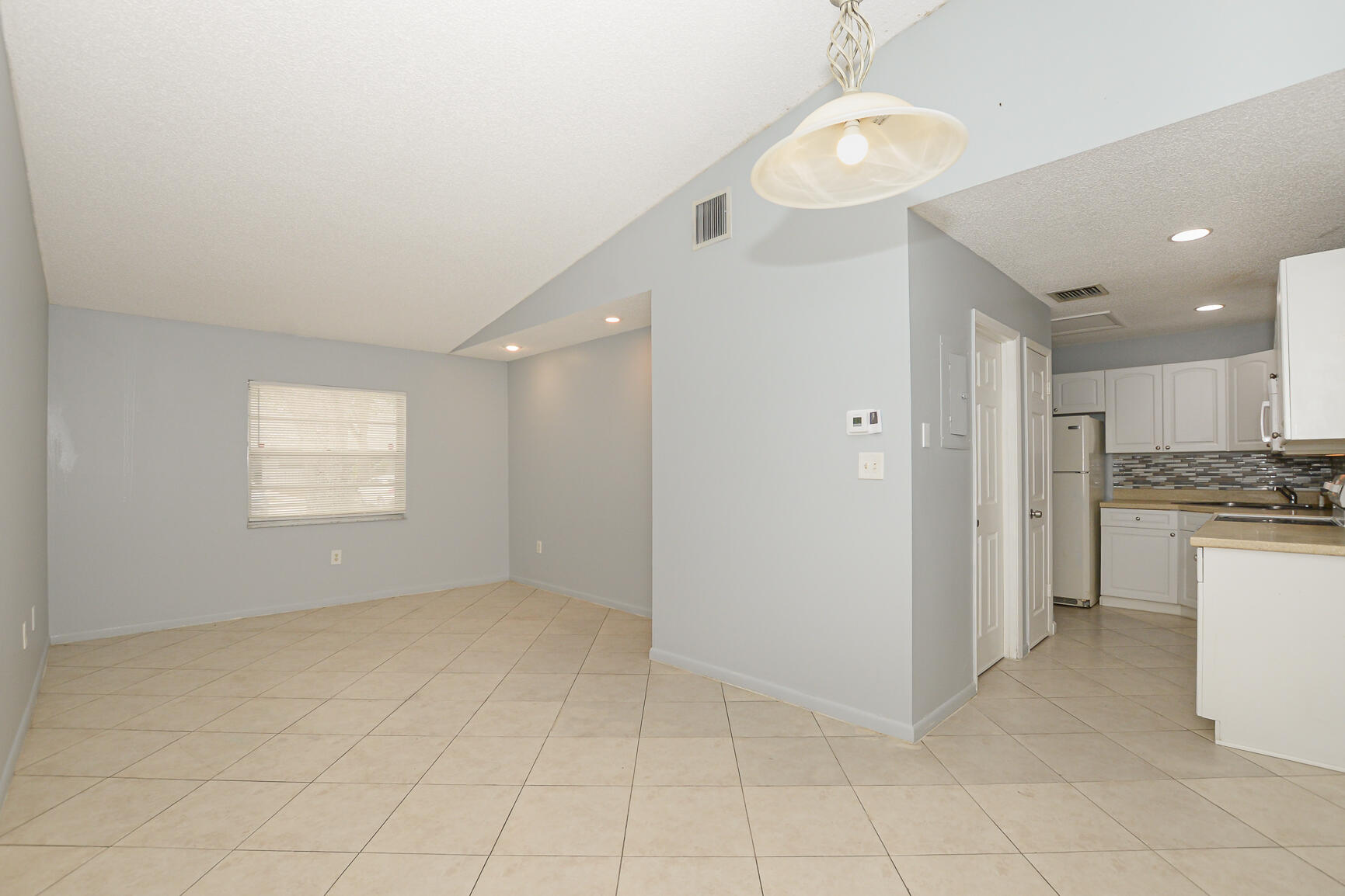 2007 Oleander Boulevard, Unit B Fort Pierce, FL 34950 - Photo 7 of 21 a view of kitchen with granite countertop cabinets and refrigerator