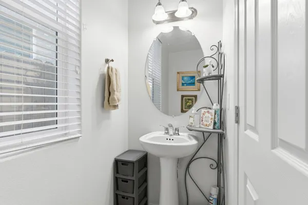 a bathroom with a granite countertop toilet sink and mirror