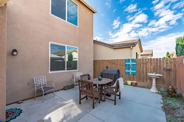 a patio with table and chairs