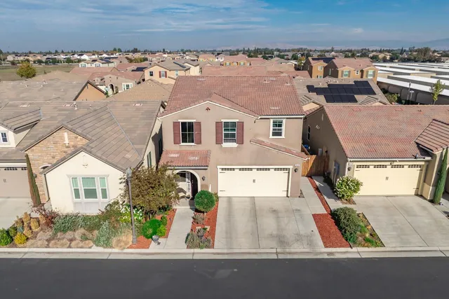 an aerial view of a house with yard