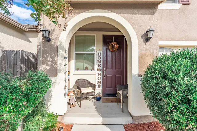 a view of a door of the house with outdoor seating