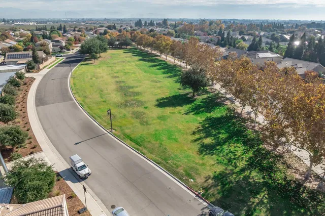 an aerial view of a house with a yard and lake view