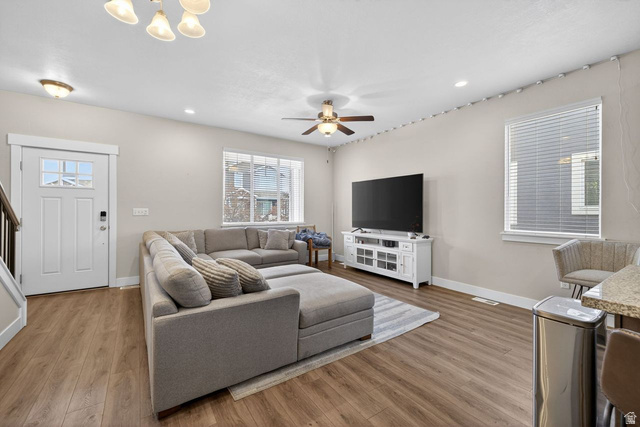 412 McClellan Court Provo, UT 84601 - Photo 12 of 20 Living room featuring wood finished floors, a ceiling fan, and hanging lights
