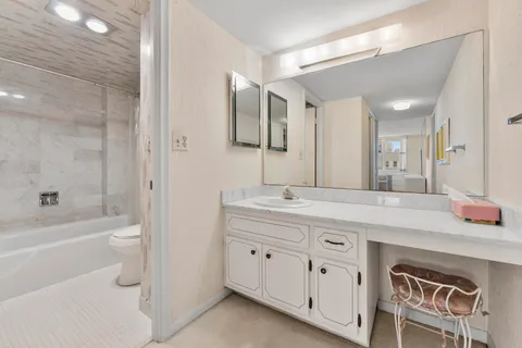 a white toilet sitting next to a bath tub