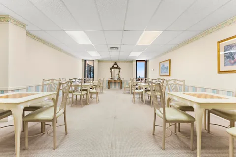 a living room with furniture a table and chairs in it