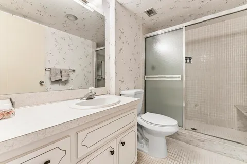 a bathroom with a sink toilet and shower