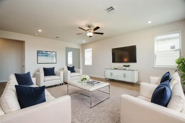 a living room with furniture and a flat screen tv