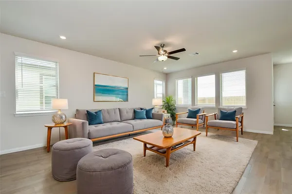 a living room with furniture and kitchen view
